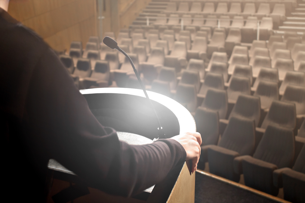 Practice is an essential part of speech preparation. Image of a presenter practicing their keynote without an audience.