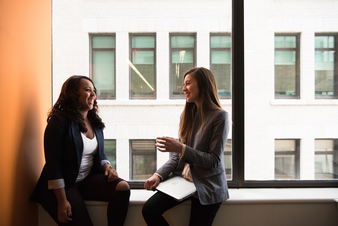 Image of two women chatting—after your keynote, be sure to connect with audience members one-on-one.