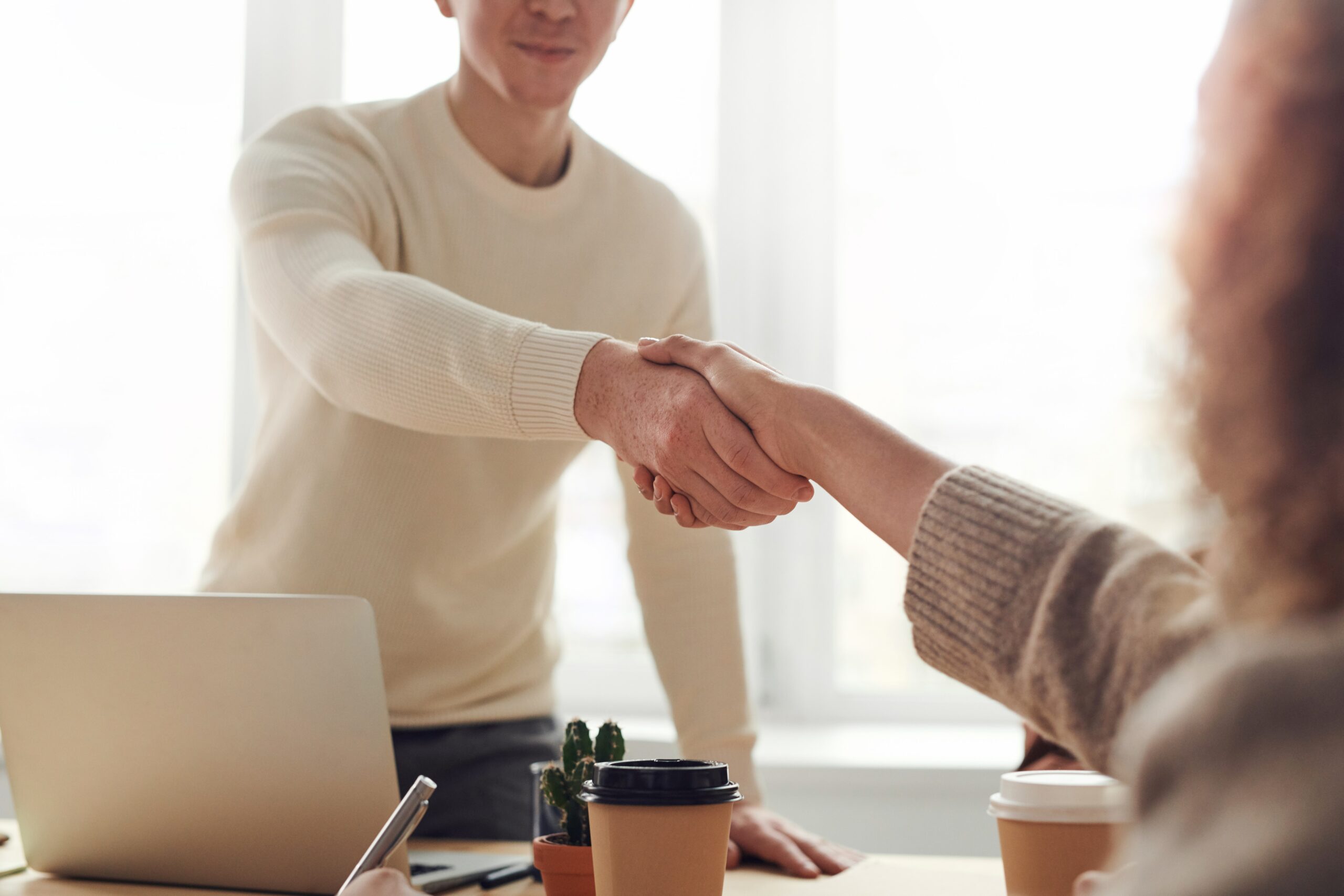 Two people shaking hands, demonstrating integrity
