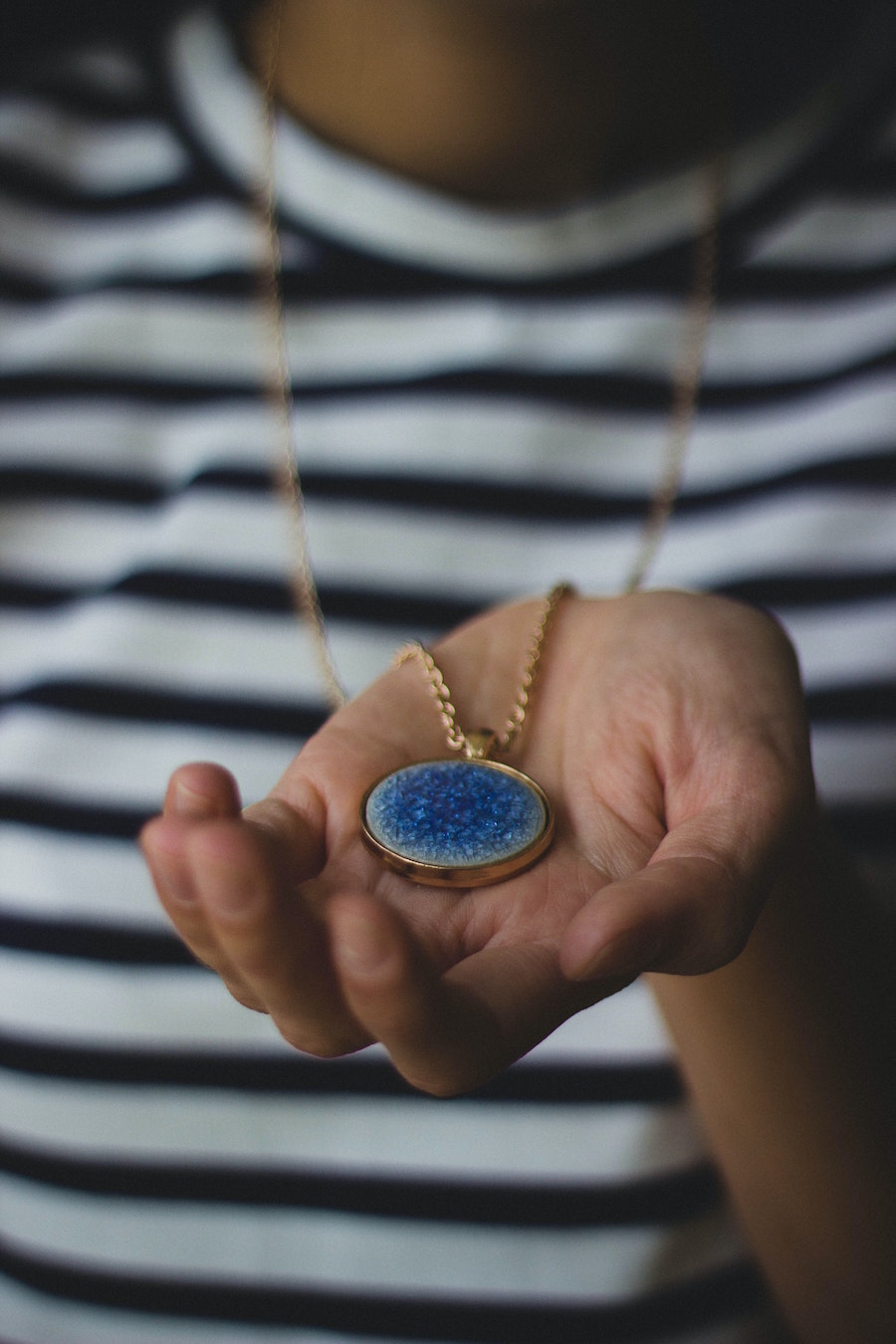 Woman holding an special necklace to help her stay grounded and focus on her upcoming presentation or speech