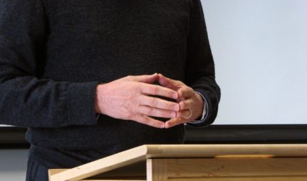 Lawyer's Pose—resting your hands naturally with the fingertips together while presenting